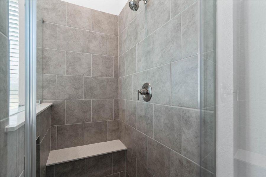 The walk-in shower includes a convenient, integrated white bench and a convenient nichef, offering comfort, extra storage space, and a high-end, custom appearance. The walk-in shower includes a convenient, integrated white bench and a convenient nichef, offering comfort, extra storage space, and a high-end, custom appearance.