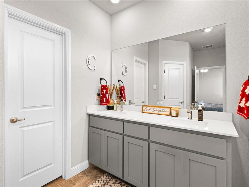 Bathroom with hardwood / wood-style floors and vanity