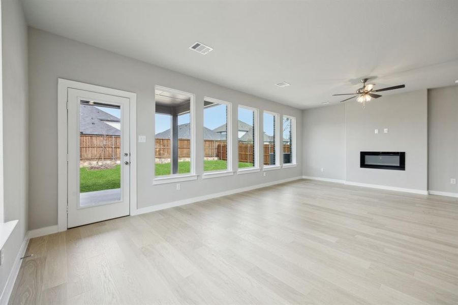 Living room with a wall of windows showcasing the backyard.