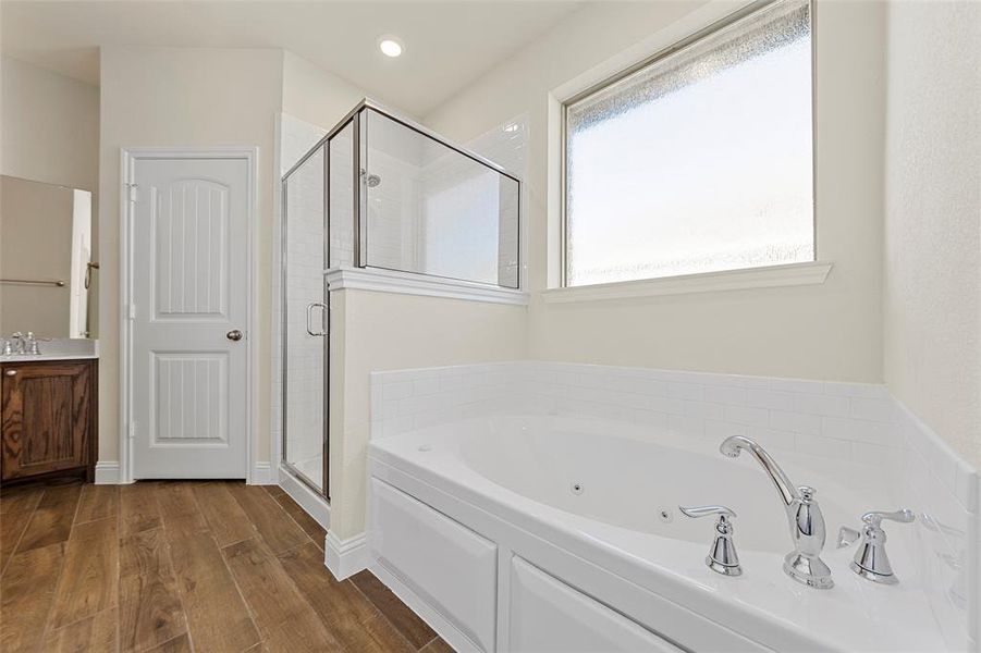 Bathroom with vanity and plus walk in shower