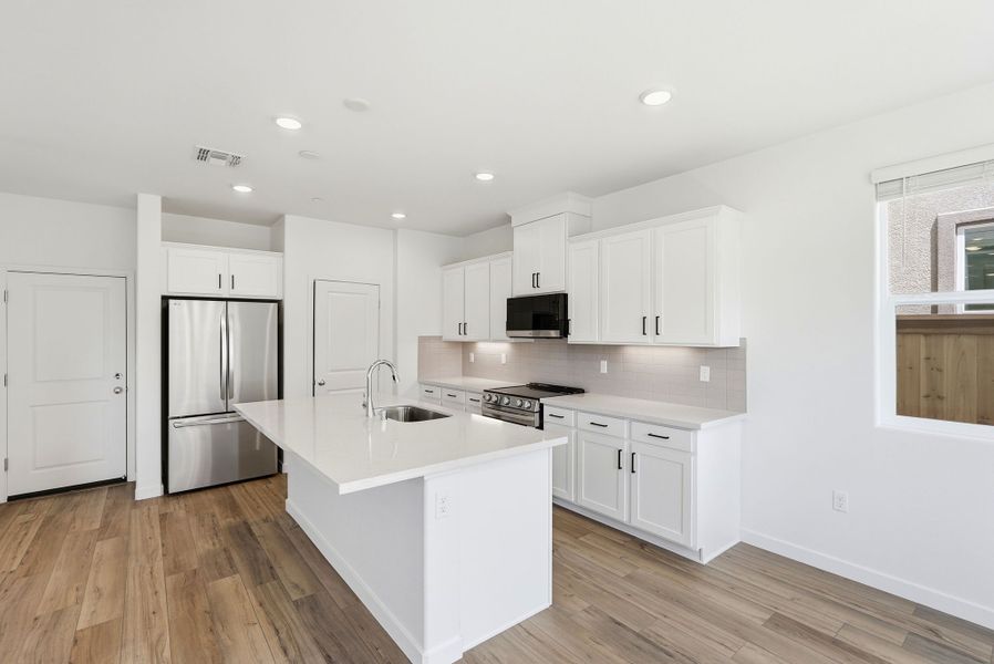 A kitchen with white cabinets. A kitchen with white cabinets.