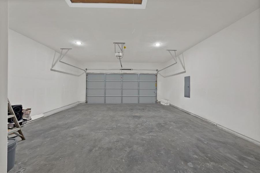Garage with electric panel and a garage door opener