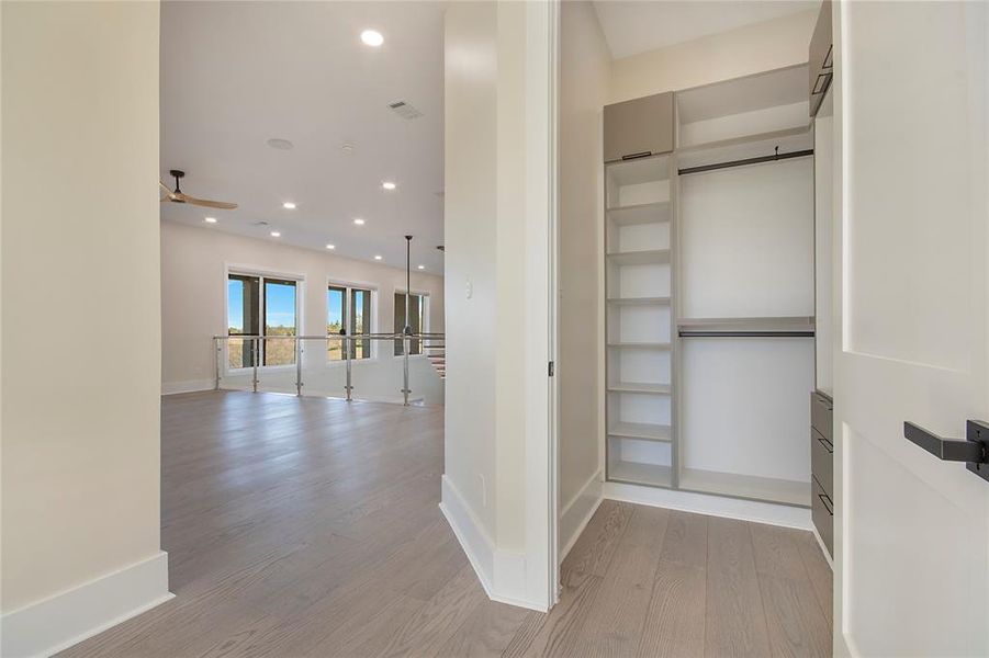 Corridor featuring recessed lighting and light wood-style flooring Corridor featuring recessed lighting and light wood-style flooring