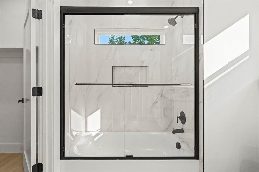 Bathroom with shower / bath combination with glass door Bathroom with shower / bath combination with glass door