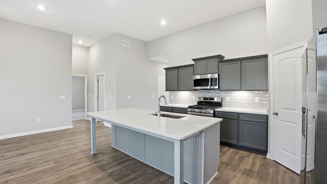 notice that the wall cabinets are the darker grey with the island lighter grey