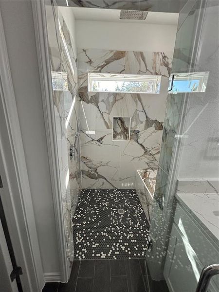 Bathroom featuring a tile shower