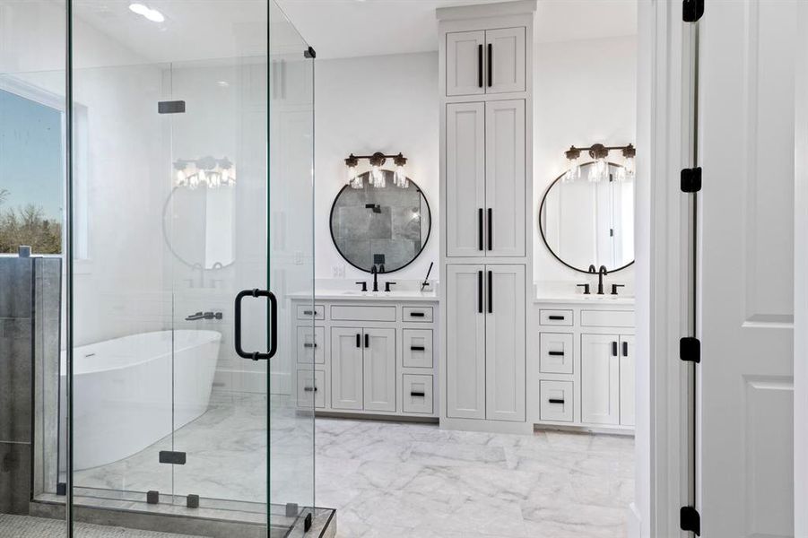 Full bathroom featuring a shower stall, a freestanding bath, vanity, and marble finish floor Full bathroom featuring a shower stall, a freestanding bath, vanity, and marble finish floor