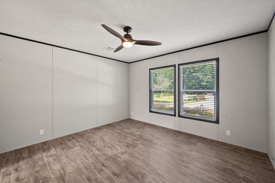 View of the primary bedroom from the living room entrance. View of the primary bedroom from the living room entrance.