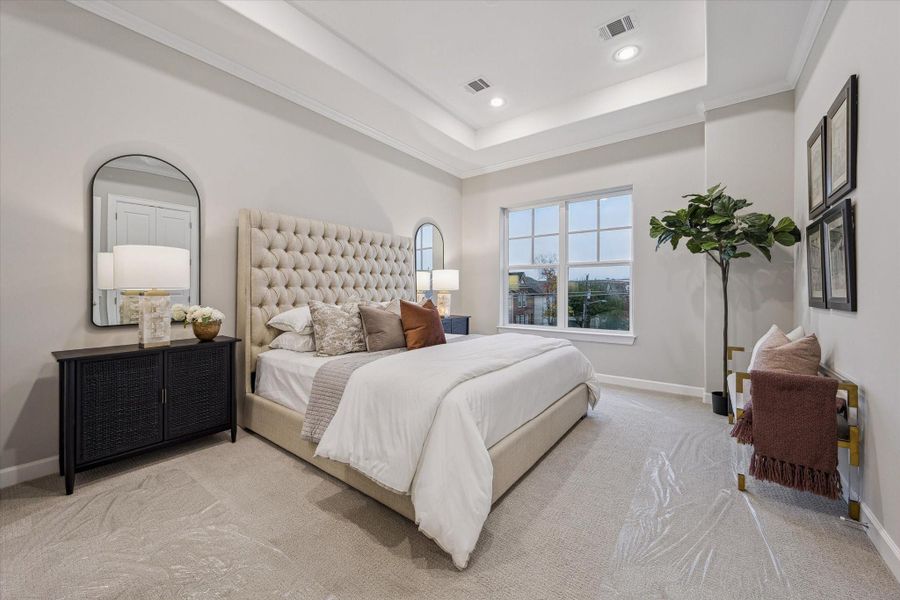 Primary bedroom with luxury carpet flooring and generous proportions.