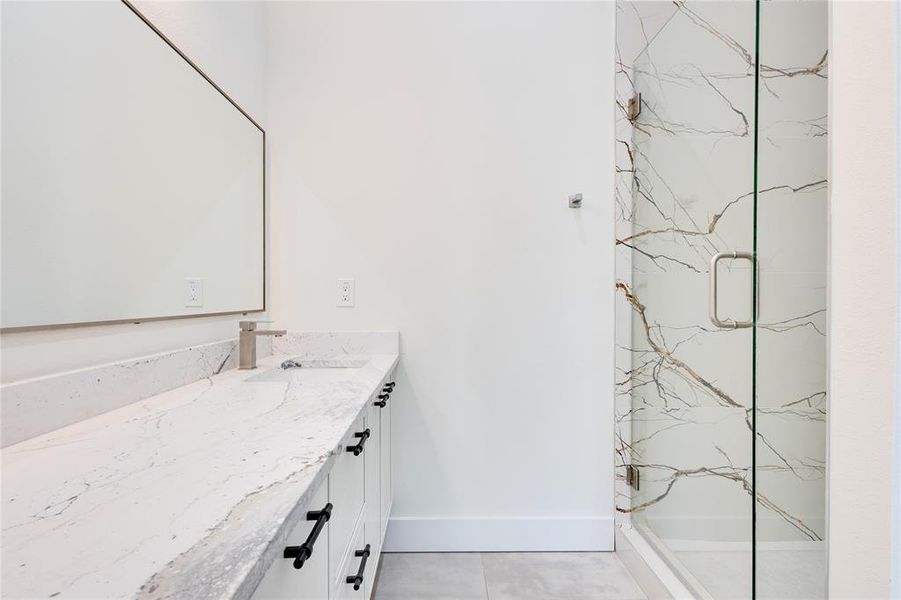 Bathroom featuring walk in shower and vanity