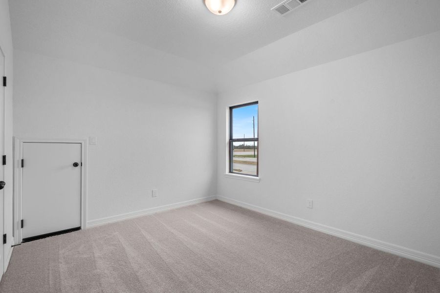 Your secondary bedroom features plush carpet, fresh paint, closet, and a large window that lets in plenty of natural lighting.