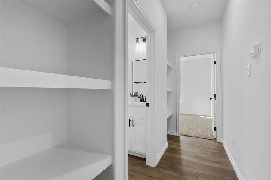 Hallway with sink and dark wood-type flooring