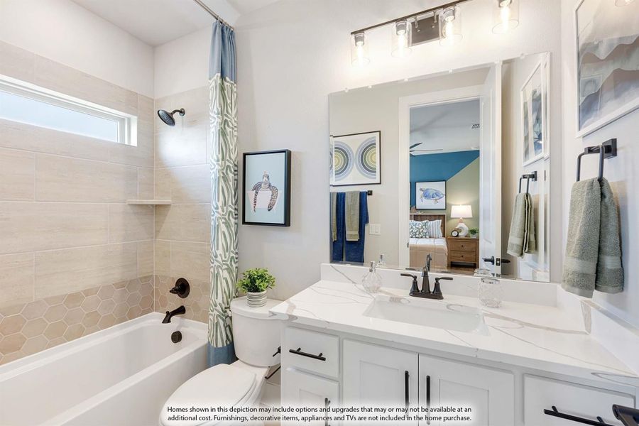 Bathroom with white vanity, quartz countertop, tiled tub-shower combo, and large mirror