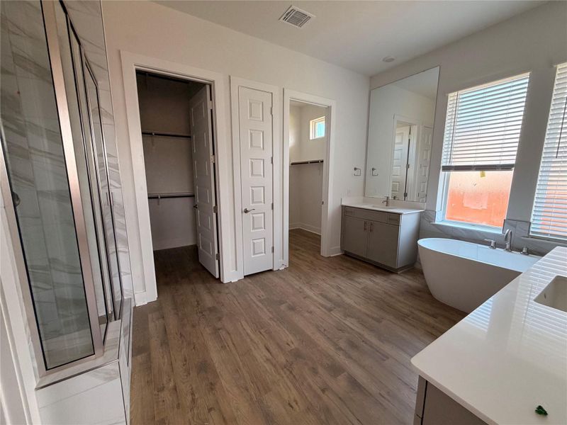 Luxurious bathroom with dual vanities, a freestanding tub, and a spacious walk-in shower. Luxurious bathroom with dual vanities, a freestanding tub, and a spacious walk-in shower.