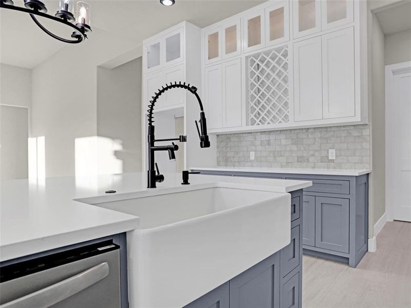 Kitchen with white cabinetry, sink, dishwasher, and gray cabinetry