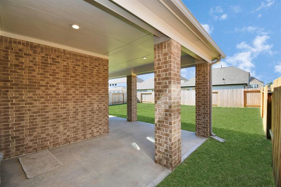 Experience outdoor living at its finest on this expansive covered patio, thoughtfully designed for BBQs and delightful outdoor dining.