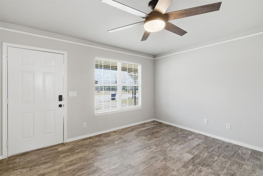 Entryway with crown molding, wood finished floors, and a ceiling fan Entryway with crown molding, wood finished floors, and a ceiling fan