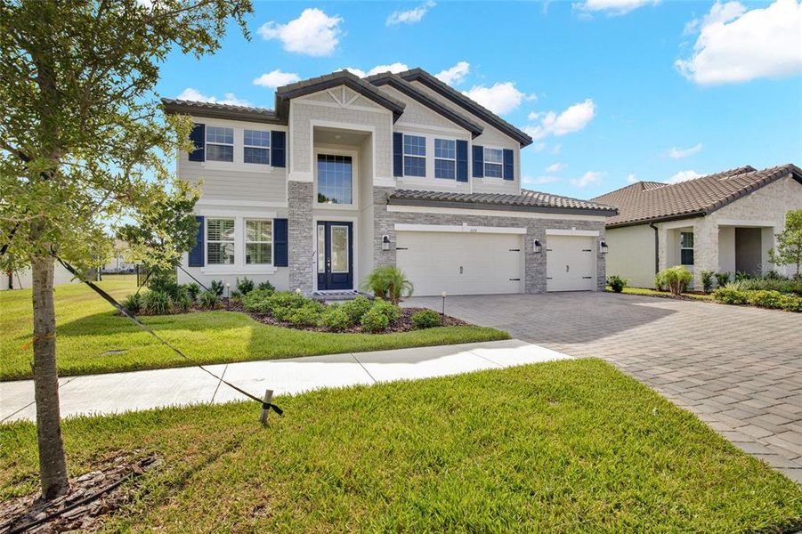 Front exterior of a new home in , Wesley Chapel, FL, highlighting curb appeal (Image 26).