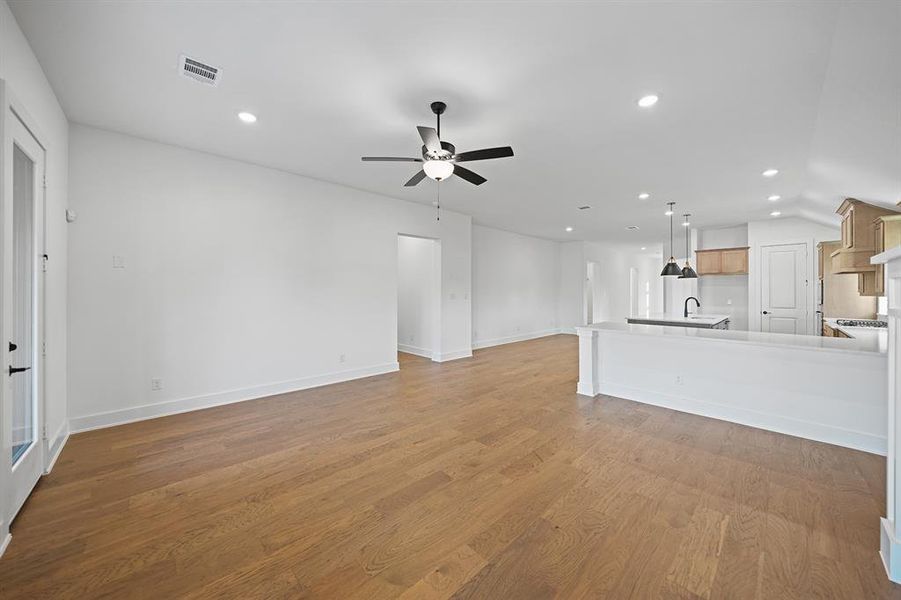 Unfurnished living room featuring recessed lighting, light wood-style floors, and a ceiling fan Unfurnished living room featuring recessed lighting, light wood-style floors, and a ceiling fan