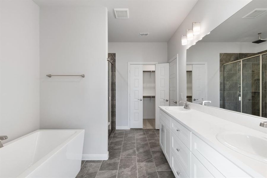 You'll enjoy this lovely owner's bath designed with two in mind!