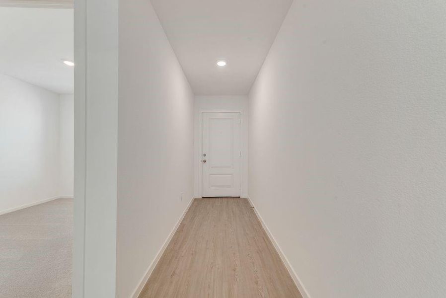 Corridor featuring light wood-type flooring