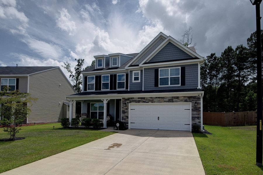 Front exterior of a new home in Oakley Pointe, Moncks Corner, SC, highlighting curb appeal (Image 25). Front exterior of a new home in Oakley Pointe, Moncks Corner, SC, highlighting curb appeal (Image 25).