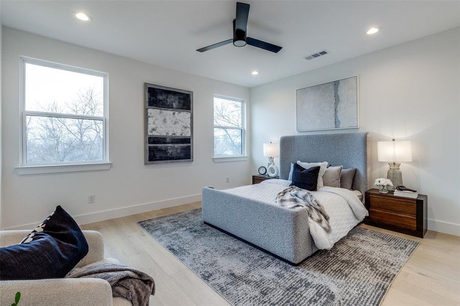 Bedroom with ceiling fan and light hardwood / wood-style flooring