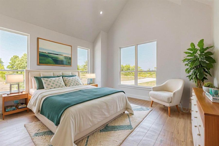 Bedroom featuring multiple windows, light wood-type flooring, and high vaulted ceiling