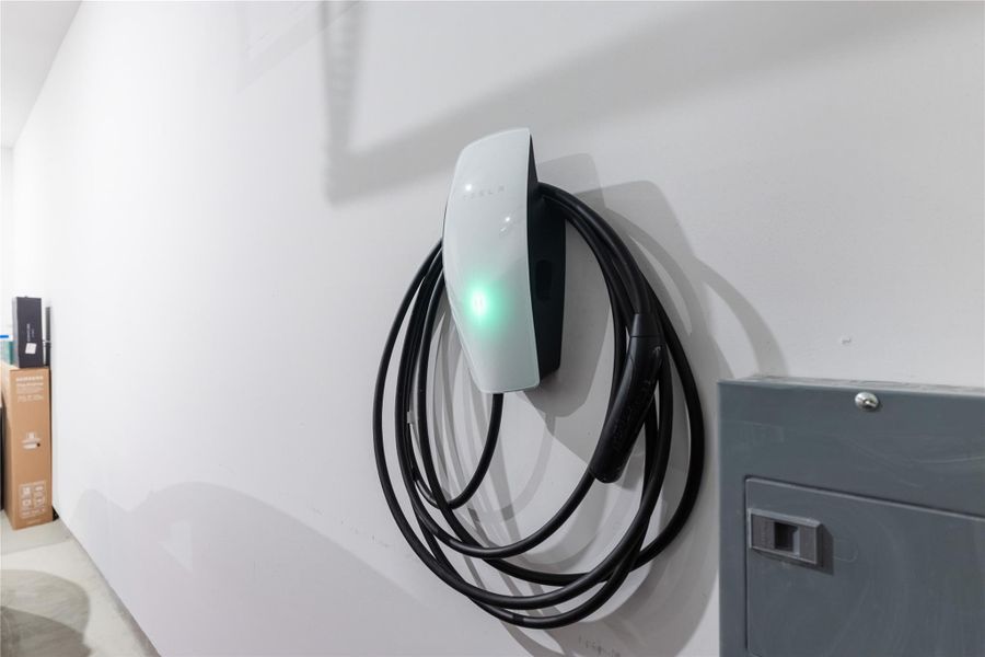 Garage view of car charger and washer / clothes dryer