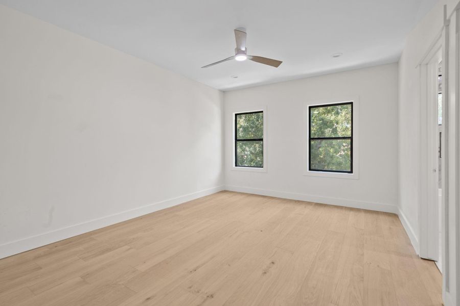 Generous windows fill the space with natural light , accentuating clean lines and versatile floor plan ideal bedroom for family members. This bedroom perfectly balances seclusion with everyday functionality.