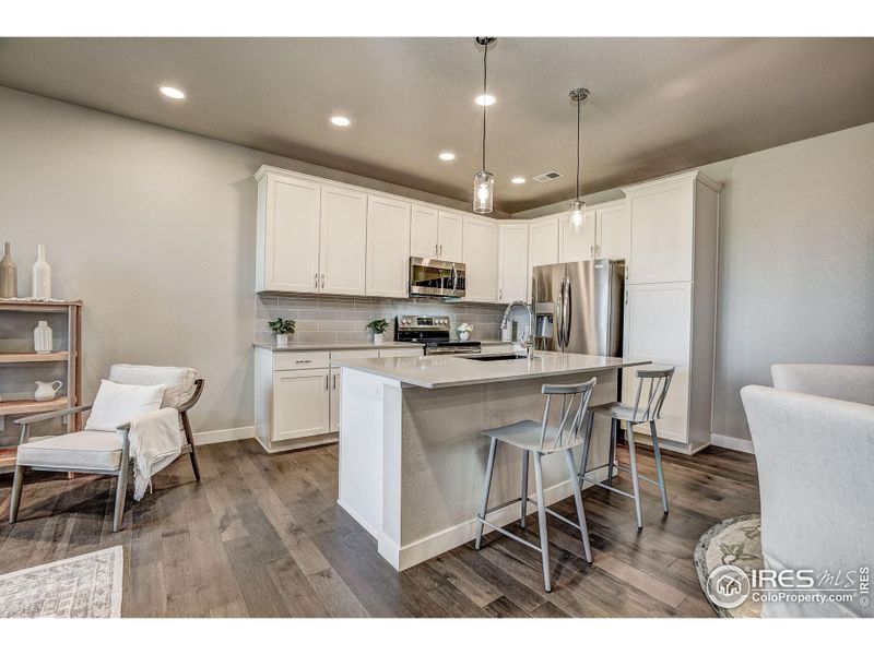 Gorgeous kitchen with island & tons of cabinet space for storage. Photos of a previously built Cascade. Finishes may vary.