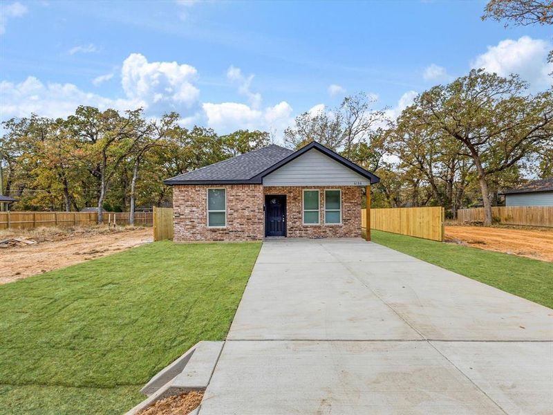 View of front of house with concrete driveway and brick siding