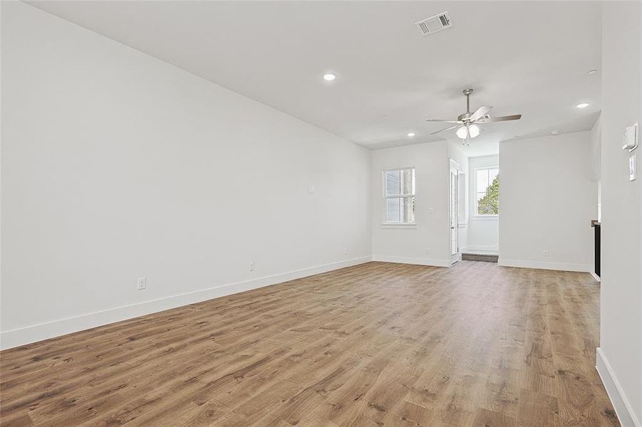 Spare room featuring ceiling fan and light wood-type flooring