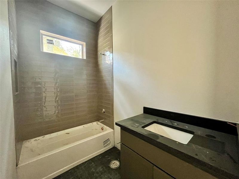 Bathroom with vanity and tiled shower / bath combo