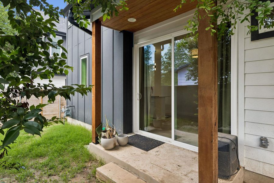 A shot of the rear exterior or private backyard space. The deck provides an ideal spot for morning coffee or evening BBQing, surrounded by a high privacy fence that creates a secluded urban retreat.