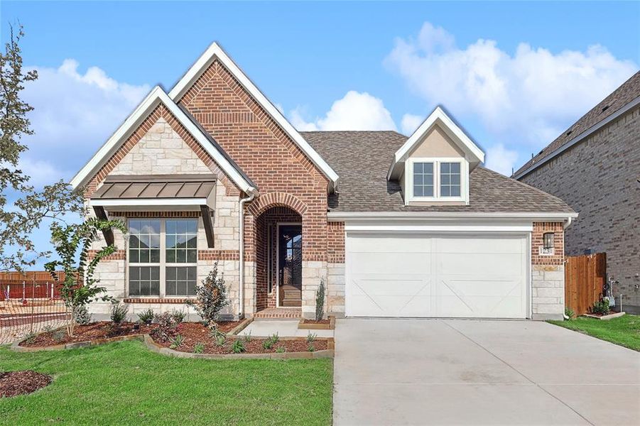 View of front of house featuring a garage and a front lawn