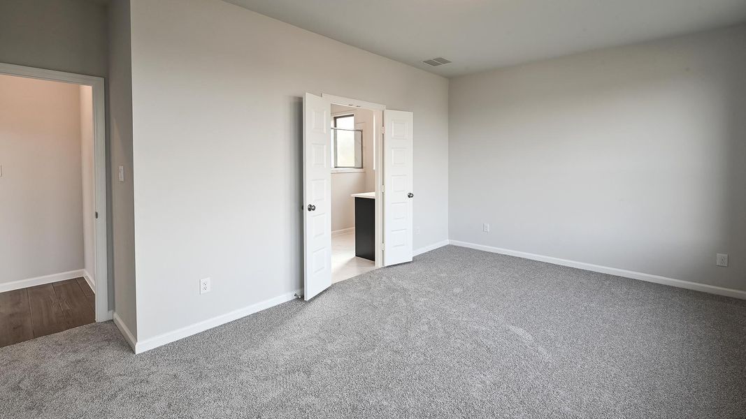 Unfurnished bedroom with baseboards and light carpet Unfurnished bedroom with baseboards and light carpet