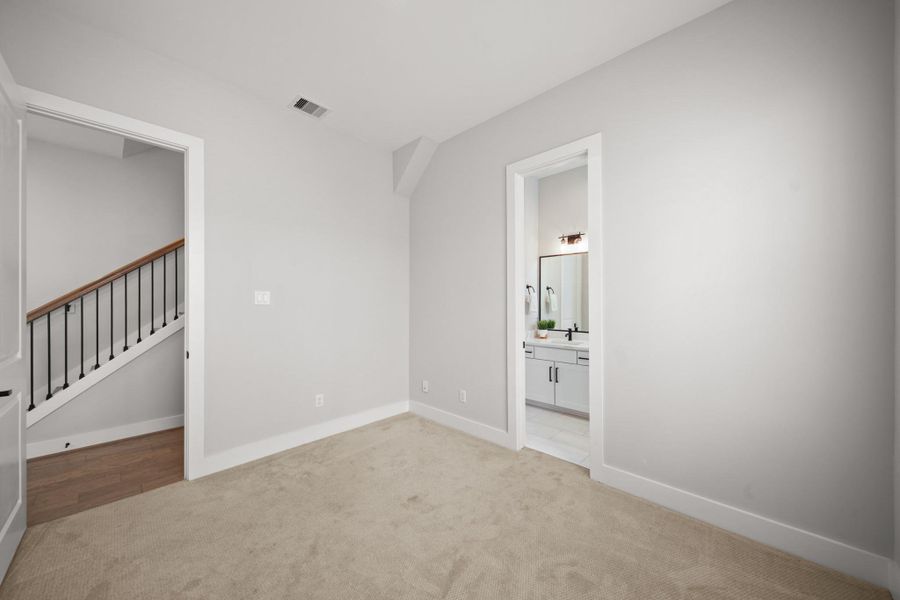 Through the door on the right, the third bedroom offers access to its own private ensuite bath, seamlessly blending comfort and thoughtful design elements. Through the door on the right, the third bedroom offers access to its own private ensuite bath, seamlessly blending comfort and thoughtful design elements.