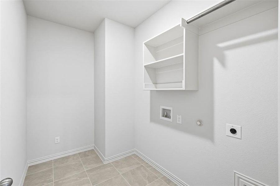 Washroom with hookup for a gas dryer, hookup for a washing machine, hookup for an electric dryer, and light tile patterned floors