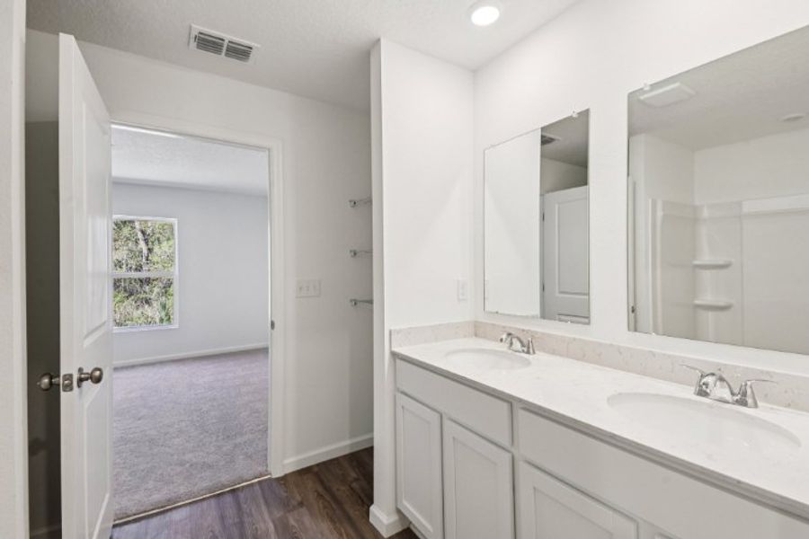 A bathroom with a large mirror.