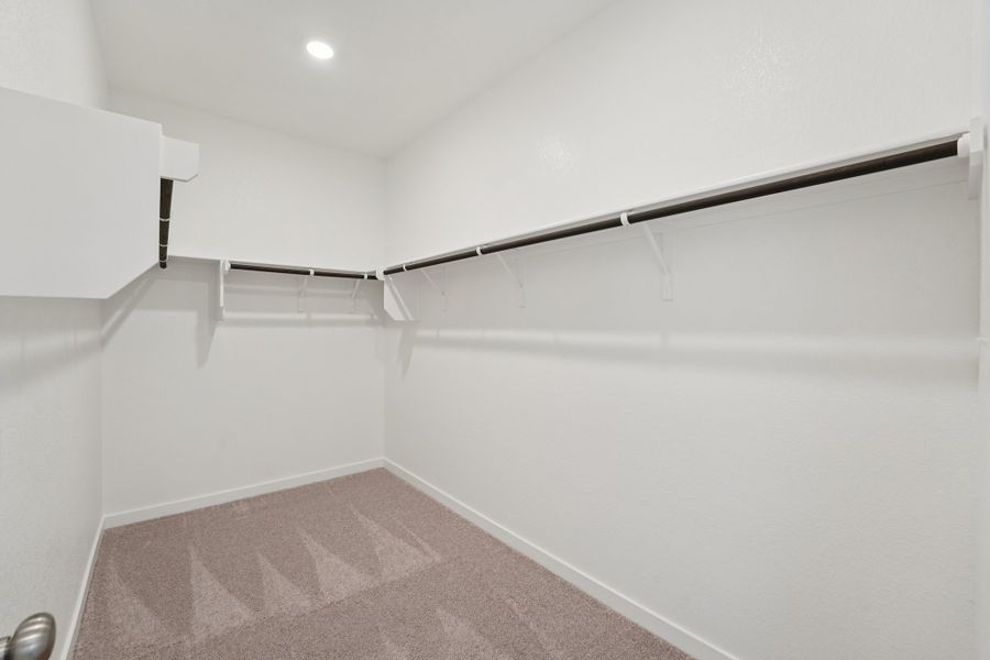 A white wall with a metal bar.