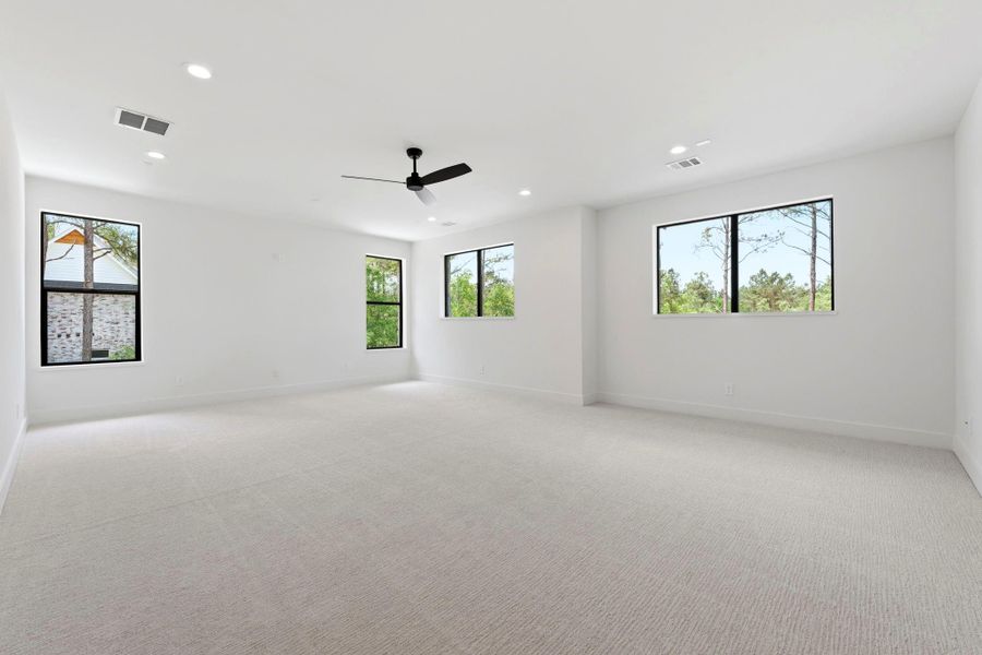SPACIOUS and light-filled upstairs FLEX ROOM featuring PLUSH carpet, black windows, and flexible layout for a Media Room, Game Room, or Gym.