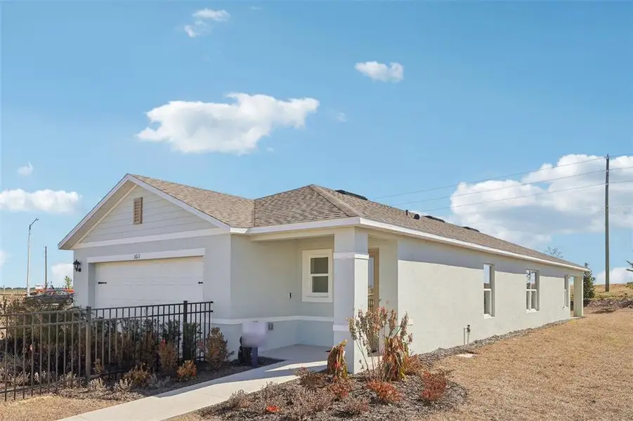 Front exterior of a new home in , Lakeland, FL, highlighting curb appeal (Image 21).