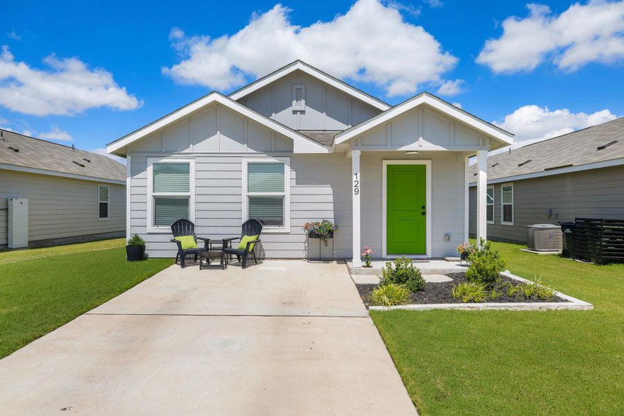 A vibrant green door welcomes you to this charming residence with a well-maintained yard. A vibrant green door welcomes you to this charming residence with a well-maintained yard.