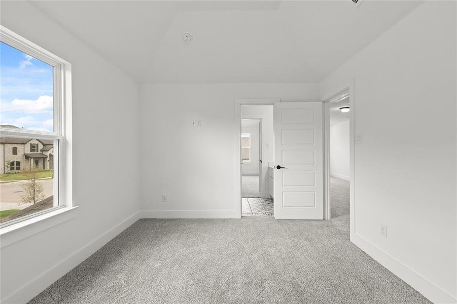 Unfurnished room featuring light carpet