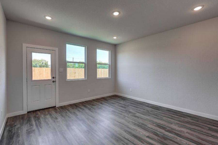 A room with a wood floor and windows. A room with a wood floor and windows.