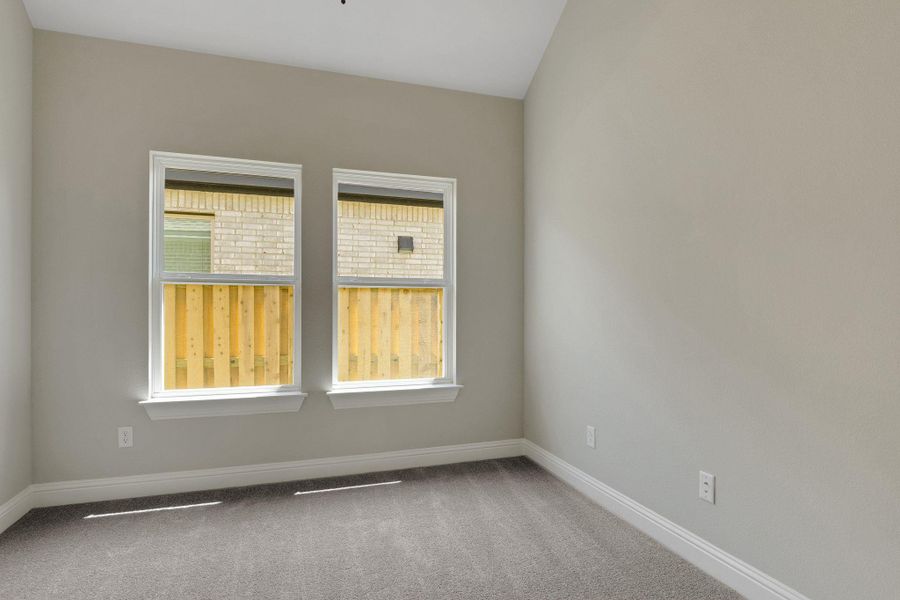 Empty room featuring carpet floors and baseboards