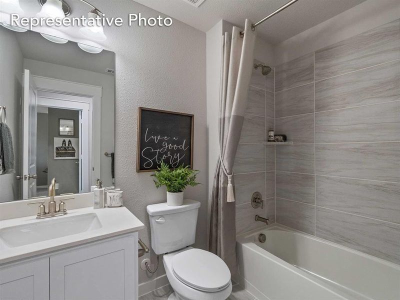 Full bathroom with shower / bath combination with curtain, toilet, a textured ceiling, and oversized vanity