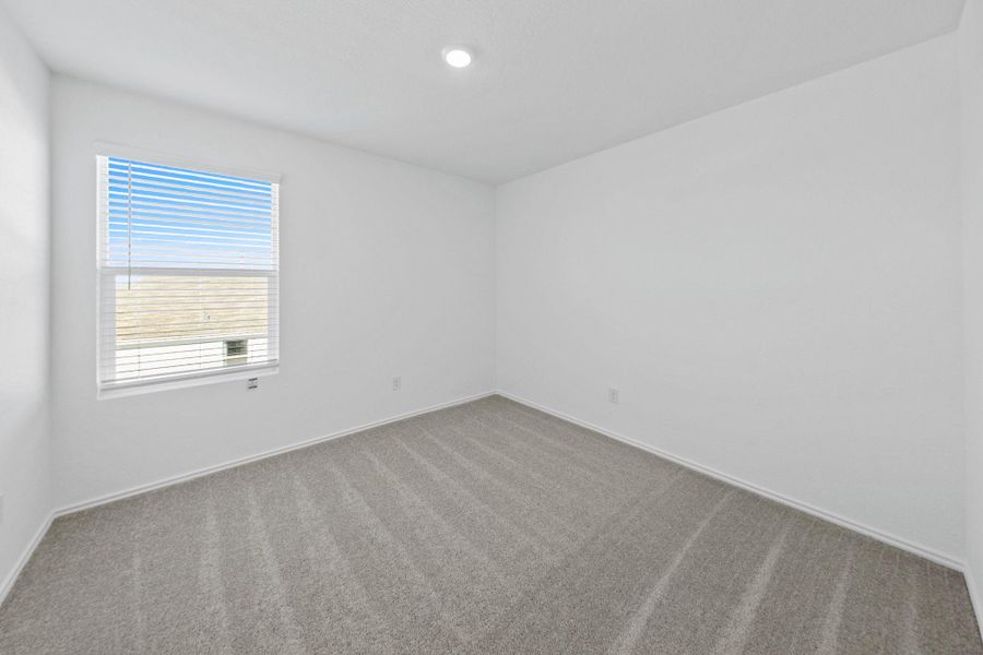 Carpeted empty room with baseboards