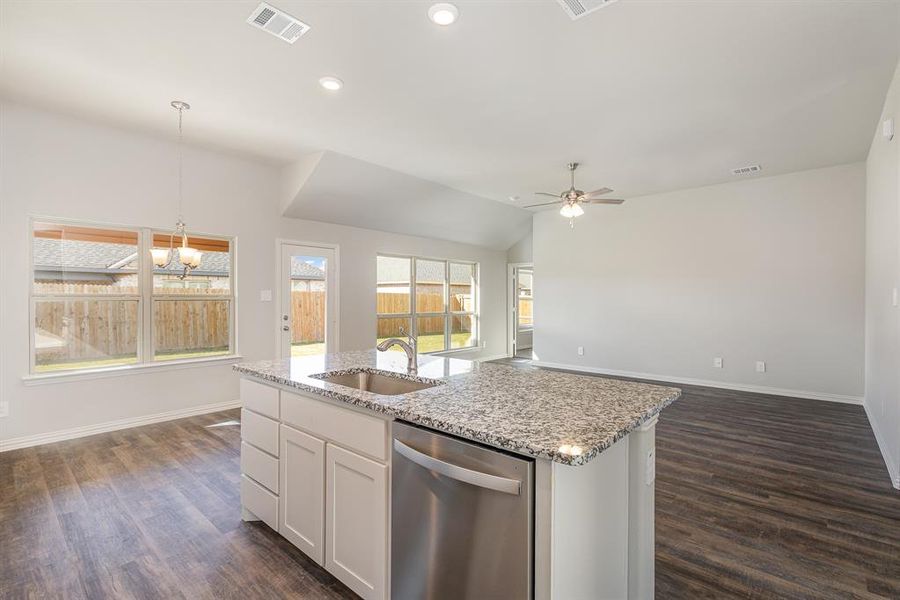 Kitchen with white cabinetry, dishwasher, dark wood-type flooring, and sink